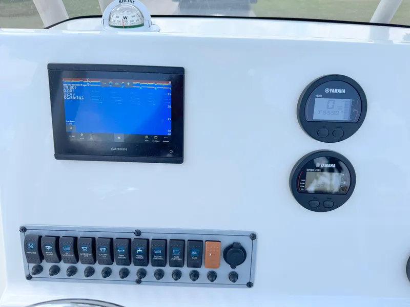 Slide: The Image of 2023 Key West 239 FS boat dashboard with Garmin display and Yamaha gauges. - 18