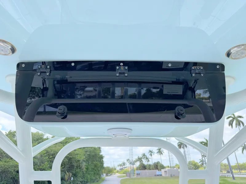 Slide: The Image of 2023 Key West 239 FS boat console with storage compartment, set against a tropical backdrop. - 20