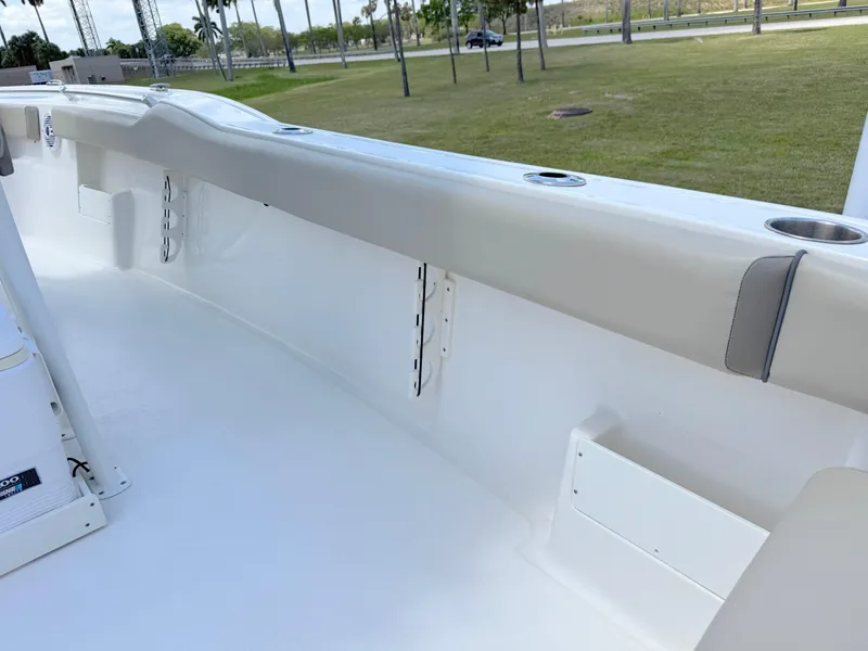 Slide: The Image of 2023 Key West 239 FS boat interior, featuring sleek white seating and cup holders. - 23