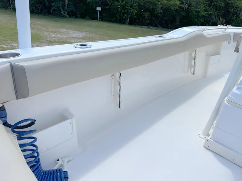 Slide: The Image of 2023 Key West 239 FS boat interior with cushioned seating and cup holders. - 24