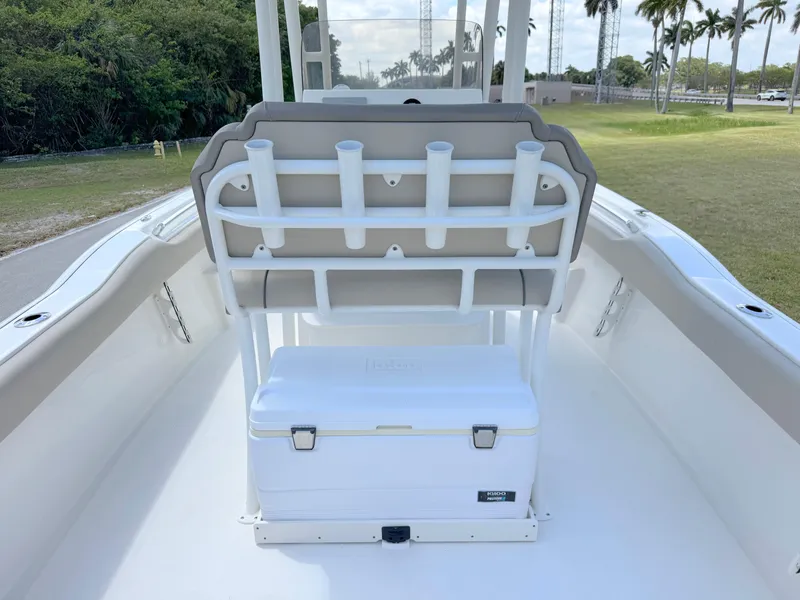 Slide: The Image of 2023 Key West 239 FS boat interior with seating and storage, featuring rod holders and cooler. - 25