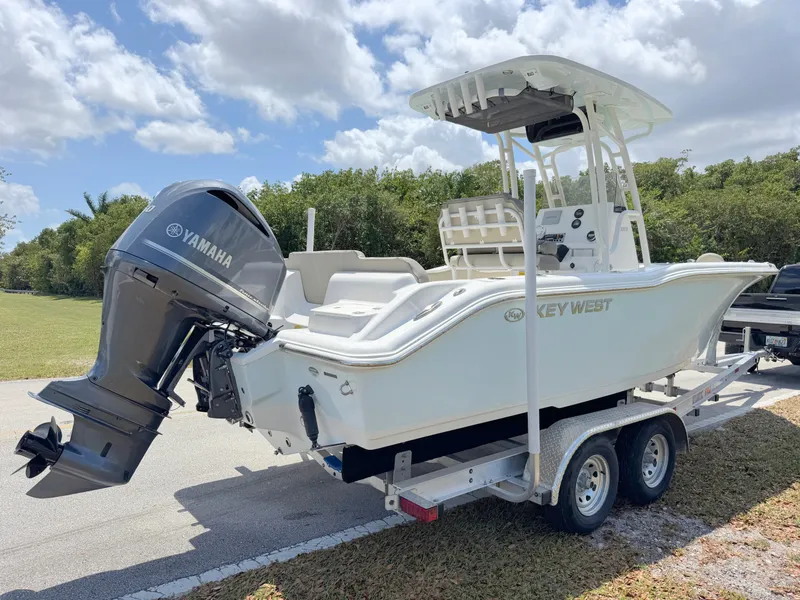 Slide: The Image of 2023 Key West 239 FS boat on trailer with Yamaha outboard motor, parked outdoors. - 4