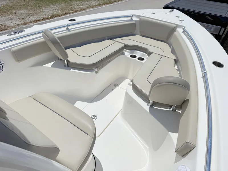 Slide: The Image of 2023 Key West 239 FS boat interior with beige seating and cup holders. - 7