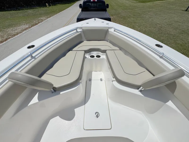 Slide: The Image of 2023 Key West 239 FS boat interior with beige seating and cup holders. - 9