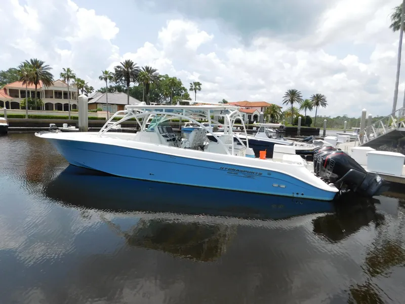 Slide: The Image of 2013 Hydra-Sports 4200 Siesta boat docked in a marina, under a partly cloudy sky. - 1