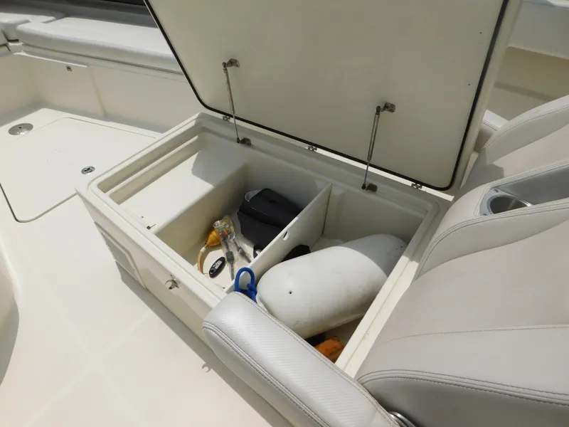 Slide: The Image of Storage compartment on 2013 Hydra-Sports 4200 Siesta boat with various items inside. - 13