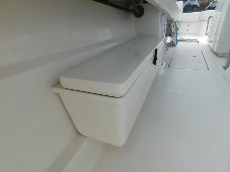 Slide: The Image of 2013 Hydra-Sports 4200 Siesta boat interior, featuring sleek white storage compartments. - 29