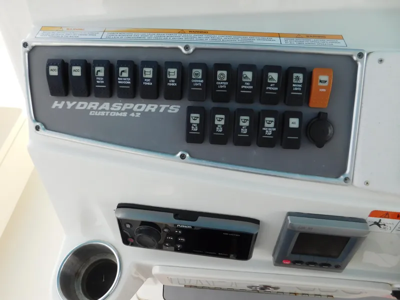 Slide: The Image of Control panel of 2013 Hydra-Sports 4200 Siesta boat with various switches and controls. - 37