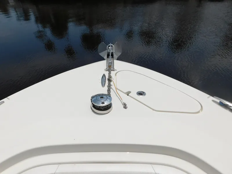 Slide: The Image of 2013 Hydra-Sports 4200 Siesta boat bow with anchor and calm water reflection. - 9