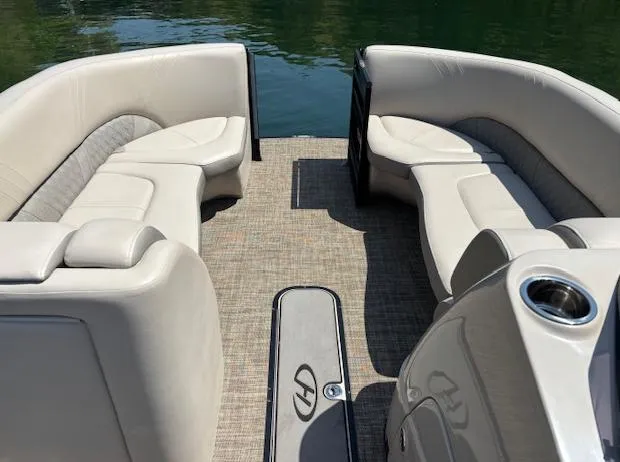 Slide: The Image of 2019 Harris Solstice 220 pontoon boat interior with beige seating and cup holder. - 3