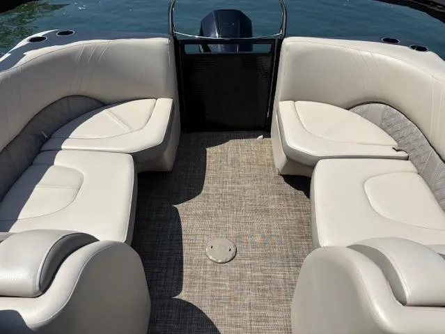 Slide: The Image of 2019 Harris Solstice 220 boat interior with beige seating and carpeted floor. - 5