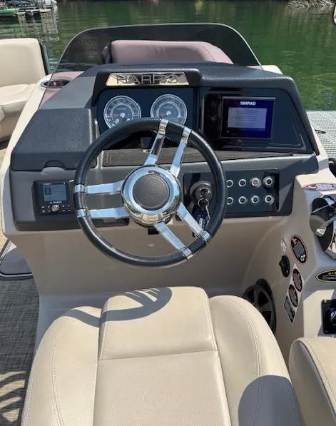 Slide: The Image of Steering console of 2019 Harris Solstice 220 boat with modern controls and gauges. - 7