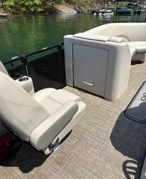 Slide: The Image of 2019 Harris Solstice 220 pontoon boat interior with beige seating and lake view. - 8