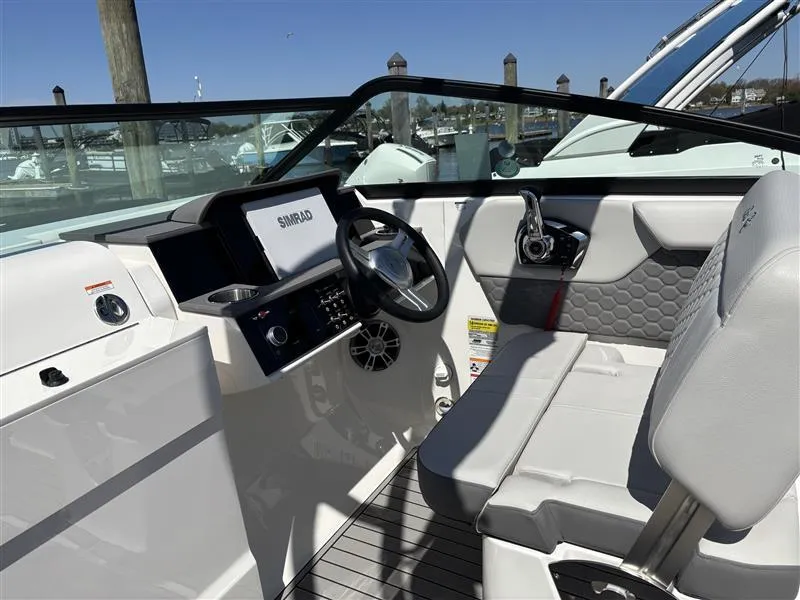 Slide: The Image of 2025 Sea Ray SDX 250 boat interior with modern dashboard and seating. - 10