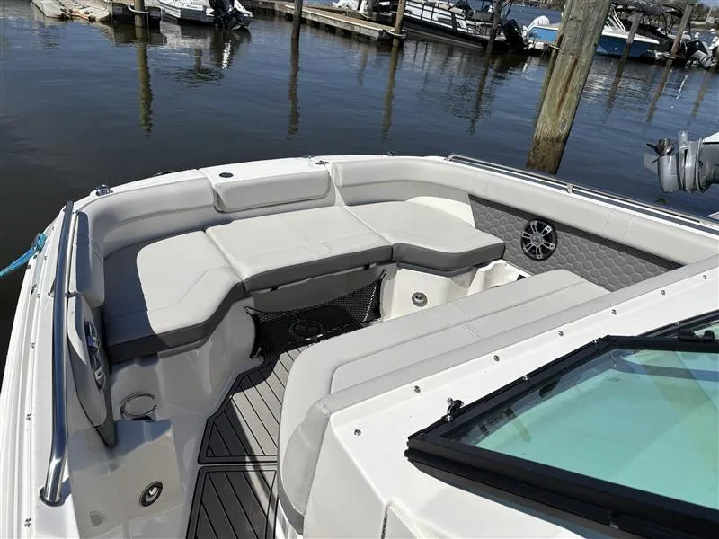 Slide: The Image of 2025 Sea Ray SDX 250 boat with spacious seating, docked at a marina. - 5