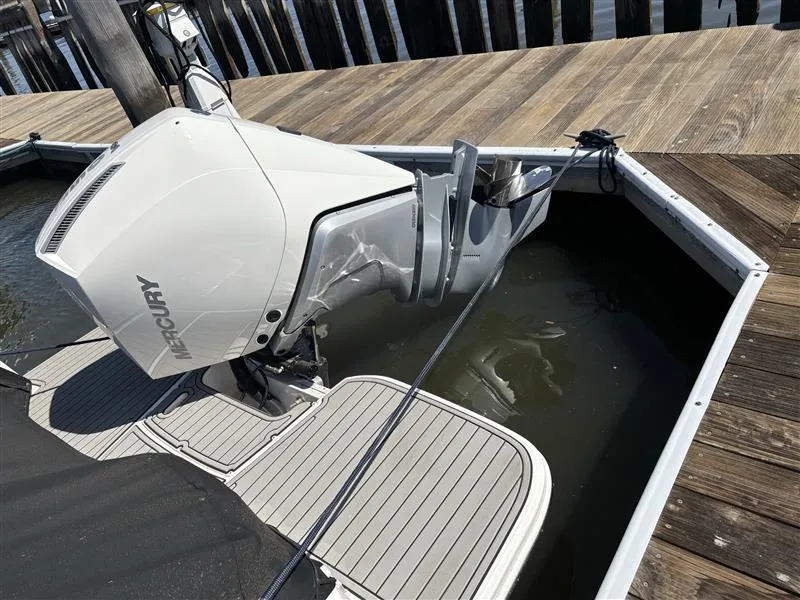 Slide: The Image of 2025 Sea Ray SDX 250 boat with Mercury outboard engine docked at marina. - 9