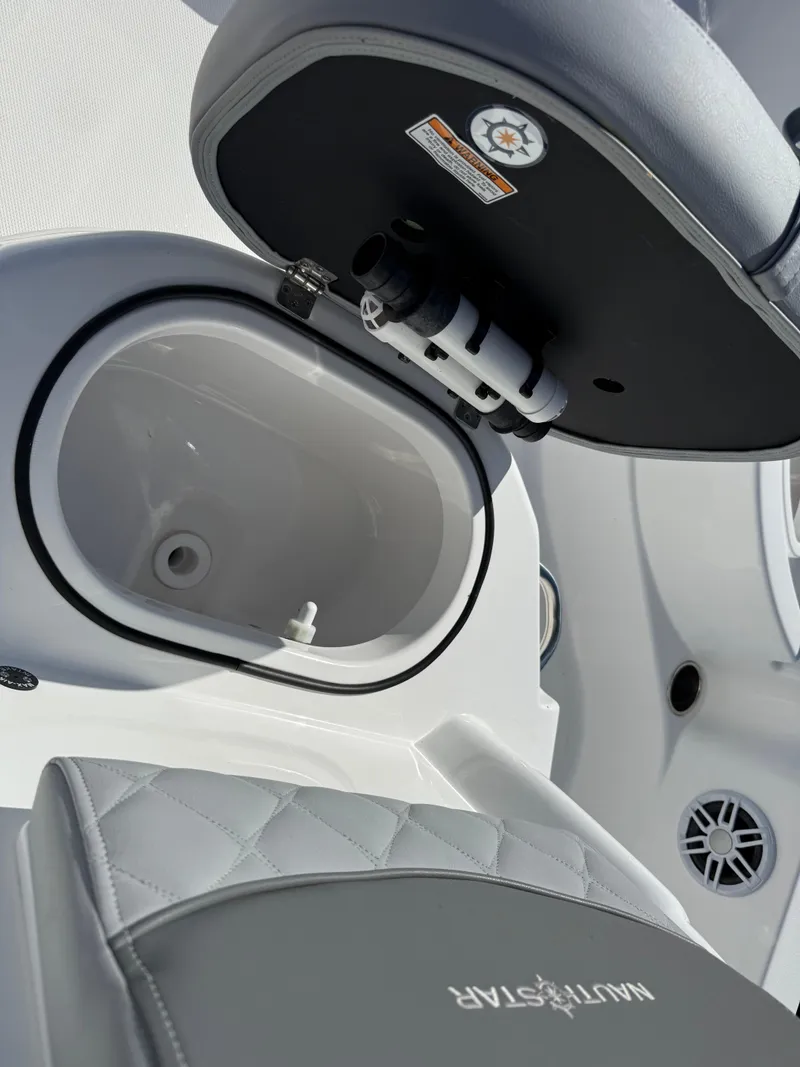 Slide: The Image of 2025 NauticStar 214 Shallow Bay boat interior with open storage compartment. - 10