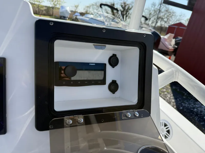 Slide: The Image of 2025 NauticStar 214 Shallow Bay dashboard with radio and controls. - 14
