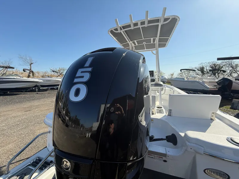 Slide: The Image of 2025 NauticStar 214 Shallow Bay boat with 150 HP engine, outdoor display. - 19