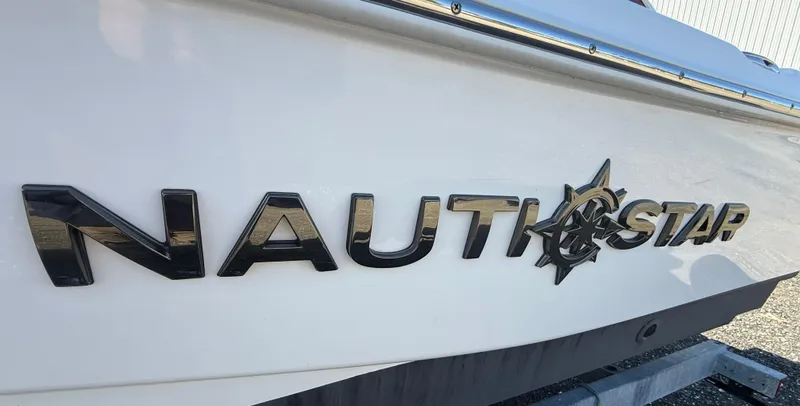 Slide: The Image of 2025 NauticStar 214 Shallow Bay boat logo on white hull. - 21