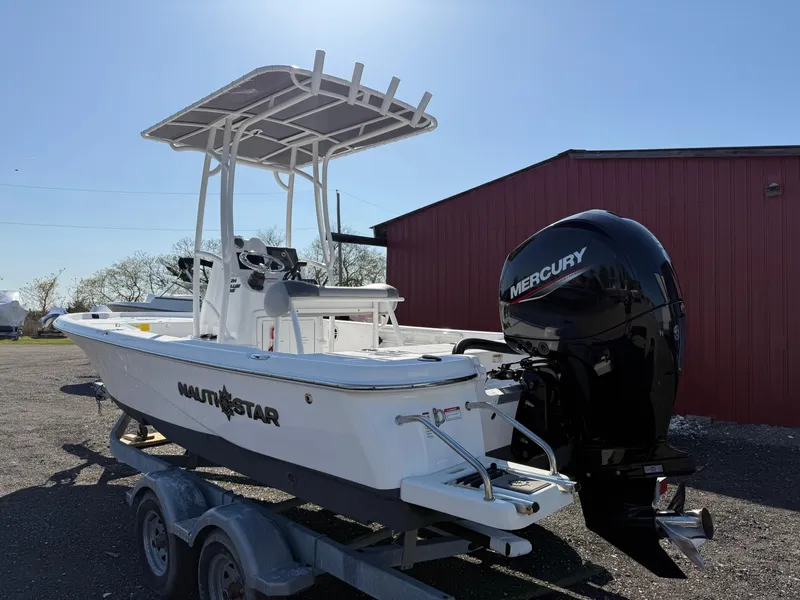 Slide: The Image of 2025 NauticStar 214 Shallow Bay boat with Mercury engine on trailer. - 3