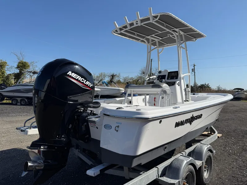 Slide: The Image of 2025 NauticStar 214 Shallow Bay boat with Mercury engine on trailer. - 5