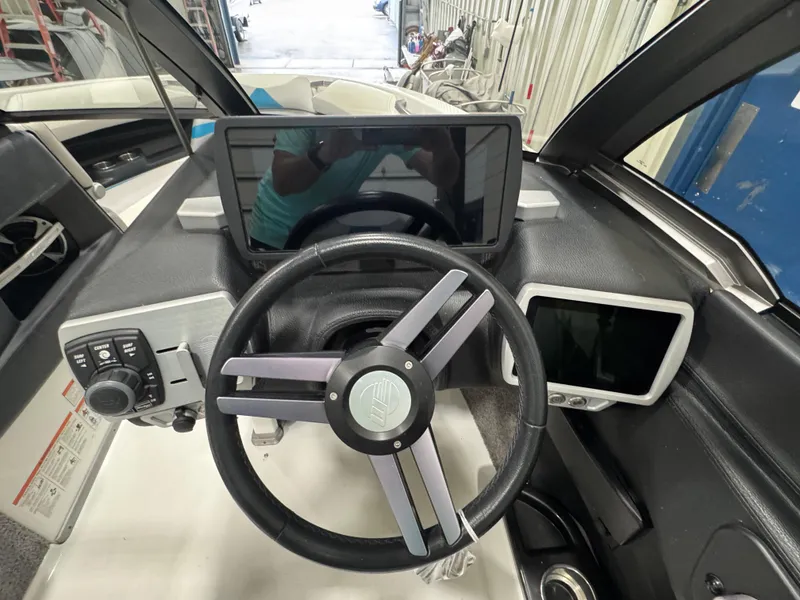Slide: The Image of 2017 Malibu Wakesetter 23 LSV dashboard with steering wheel and digital displays. - 13