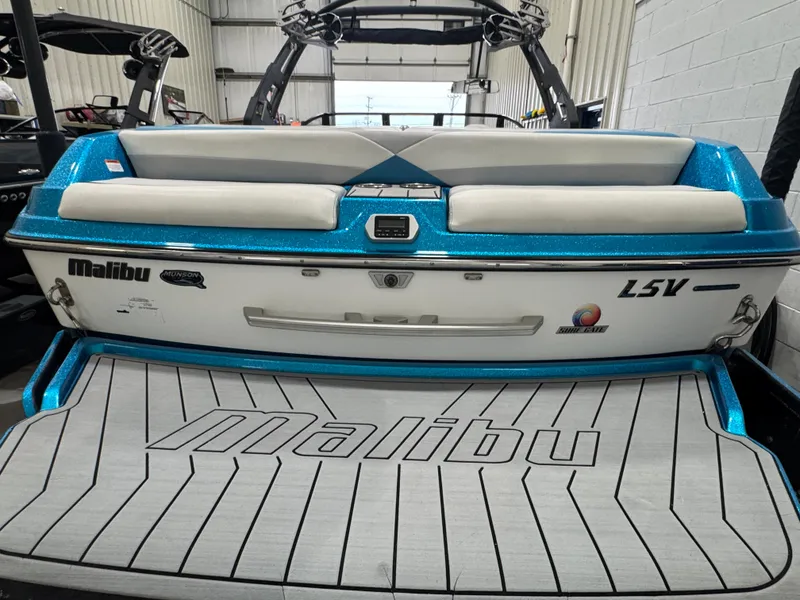 Slide: The Image of 2017 Malibu Wakesetter 23 LSV boat, blue and white, rear view in a garage. - 3