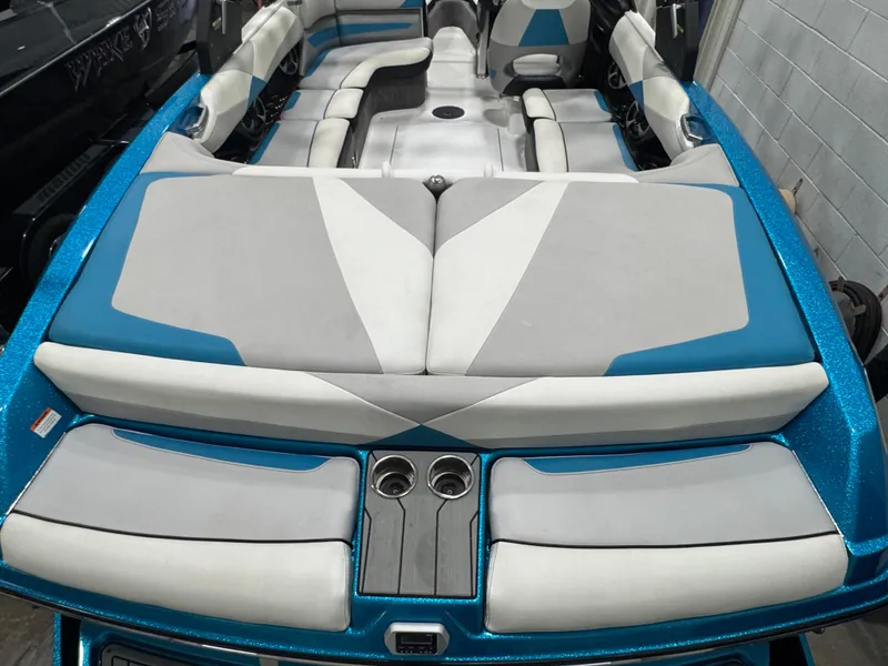 Slide: The Image of 2017 Malibu Wakesetter 23 LSV boat interior with blue and white seating. - 4
