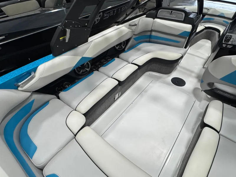 Slide: The Image of 2017 Malibu Wakesetter 23 LSV interior with white and blue seating, spacious layout. - 5