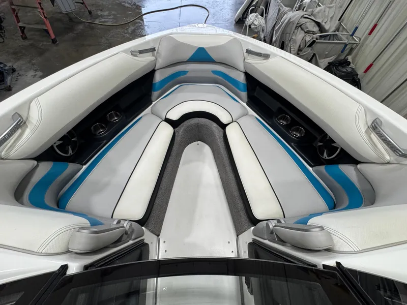 Slide: The Image of 2017 Malibu Wakesetter 23 LSV boat interior with white and blue seating. - 7