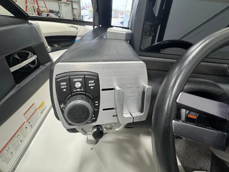 Slide: The Image of 2017 Malibu Wakesetter 23 LSV dashboard with control panel and steering wheel. - 9