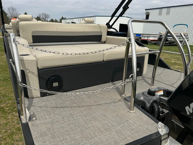Slide: The Image of 2021 Barletta C24UC Triple Toon pontoon boat with beige seating and stainless steel railings. - 10