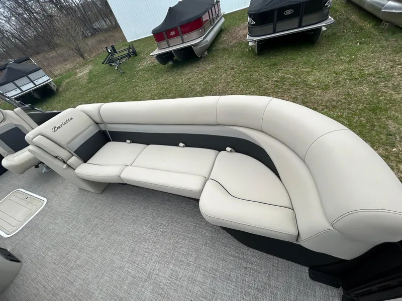 Slide: The Image of 2021 Barletta C24UC Triple Toon pontoon boat with beige seating on display. - 13