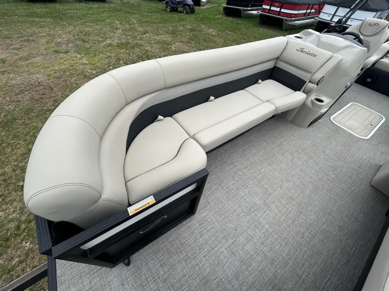 Slide: The Image of 2021 Barletta C24UC Triple Toon boat with beige seating and spacious deck. - 14