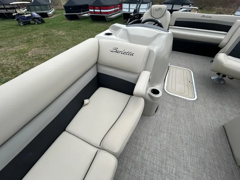 Slide: The Image of 2021 Barletta C24UC Triple Toon pontoon boat with beige seating and spacious interior. - 15
