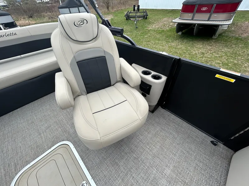 Slide: The Image of Luxurious seating on 2021 Barletta C24UC Triple Toon pontoon boat, featuring cup holders. - 17