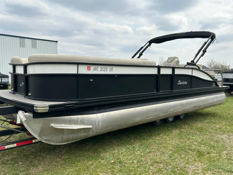 Slide: The Image of 2021 Barletta C24UC Triple Toon pontoon boat on grass, overcast sky. - 2