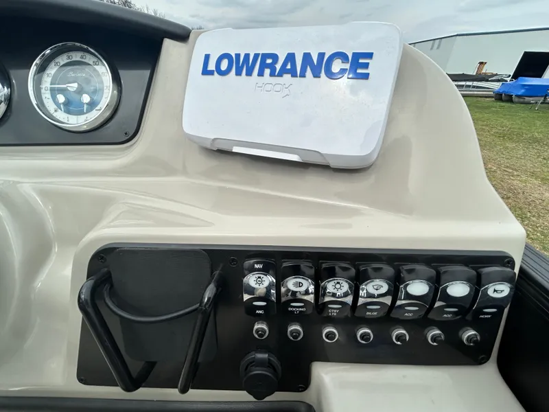 Slide: The Image of Control panel of 2021 Barletta C24UC Triple Toon with Lowrance Hook display. - 21