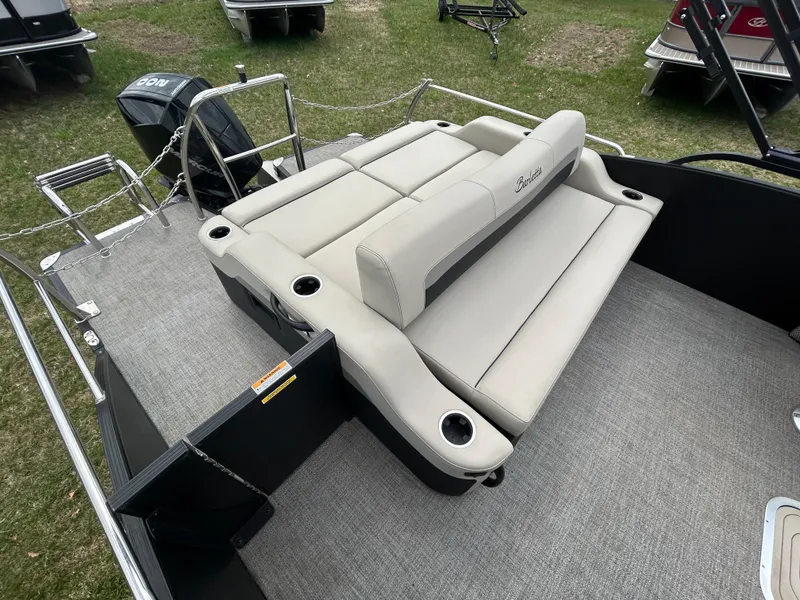 Slide: The Image of 2021 Barletta C24UC Triple Toon boat with beige seating and cup holders on deck. - 22