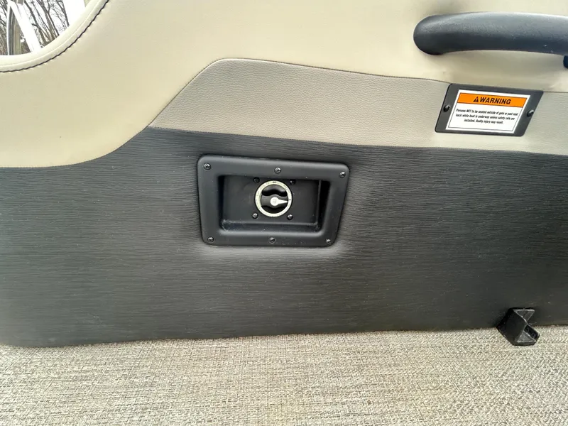 Slide: The Image of Interior detail of 2021 Barletta C24UC Triple Toon boat, featuring a built-in cup holder. - 25