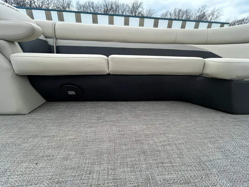 Slide: The Image of 2021 Barletta C24UC Triple Toon boat interior with beige seating and carpeted flooring. - 26