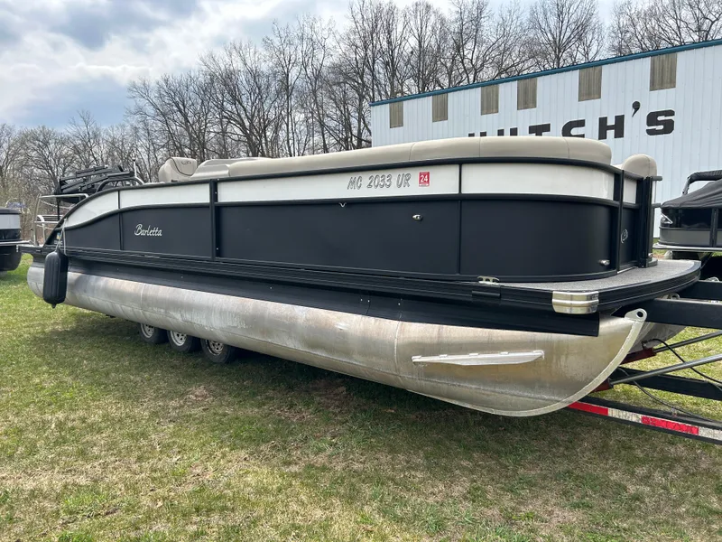 Slide: The Image of 2021 Barletta C24UC Triple Toon pontoon boat on grass near a building. - 28