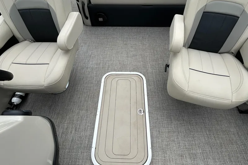 Slide: The Image of 2021 Barletta C24UC Triple Toon interior with beige seats and carpeted flooring. - 32