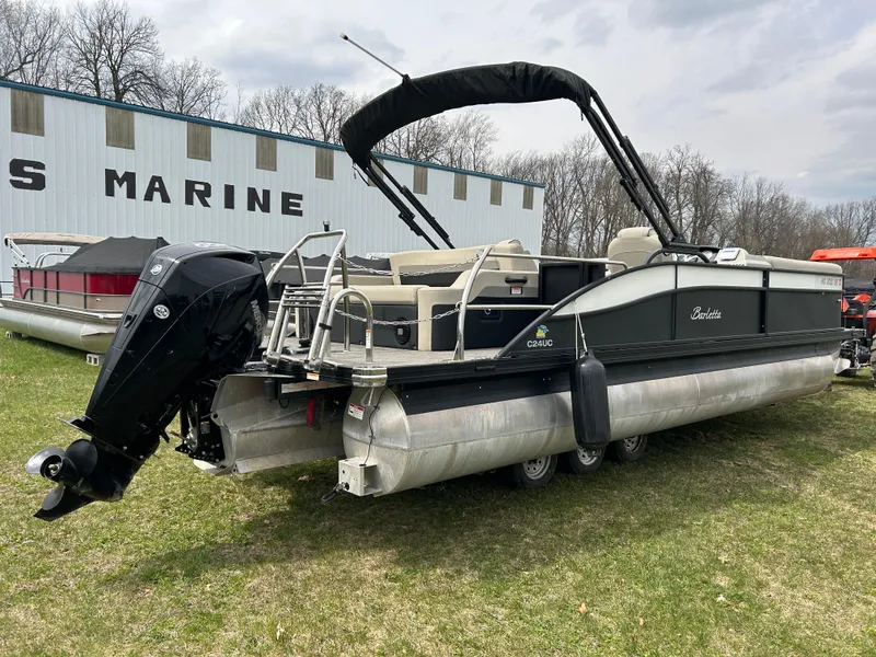 Slide: The Image of 2021 Barletta C24UC Triple Toon pontoon boat on grass near marine building. - 6