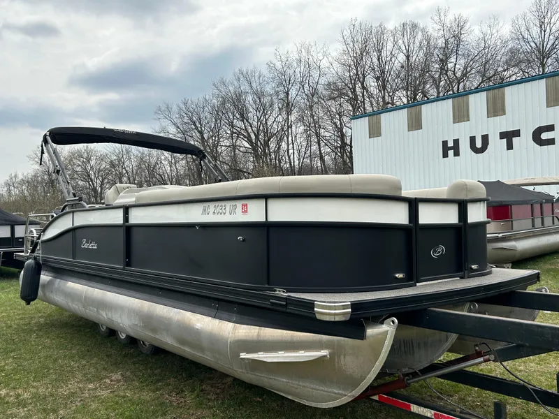 Slide: The Image of 2021 Barletta C24UC Triple Toon pontoon boat on trailer, parked outdoors. - 8