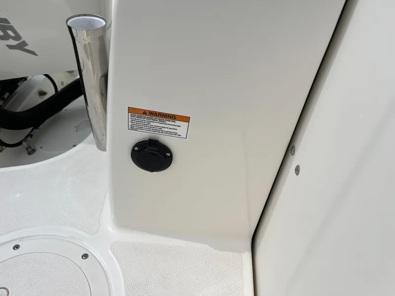 Slide: The Image of 2025 Boston Whaler 240 Vantage boat detail with warning label and deck features. - 11