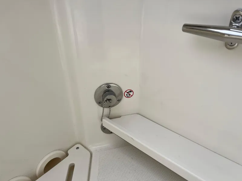 Slide: The Image of Interior detail of 2025 Boston Whaler 240 Vantage boat, featuring a metal handle and chain. - 12