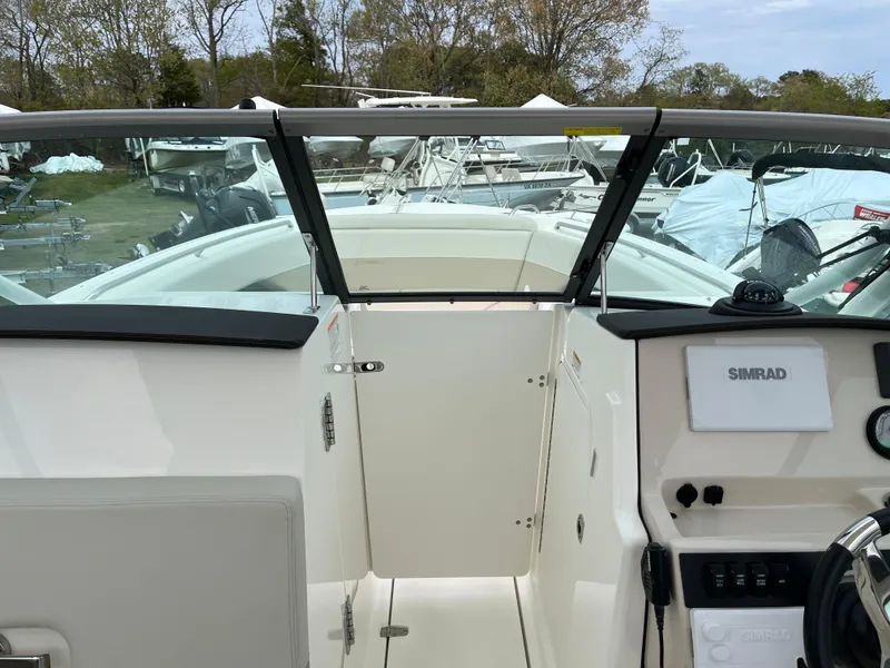 Slide: The Image of 2025 Boston Whaler 240 Vantage boat interior with Simrad navigation system. - 16