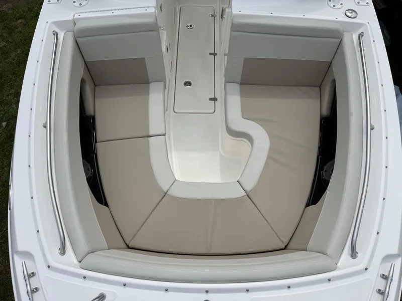 Slide: The Image of 2025 Boston Whaler 240 Vantage boat interior with cushioned seating and sleek design. - 17